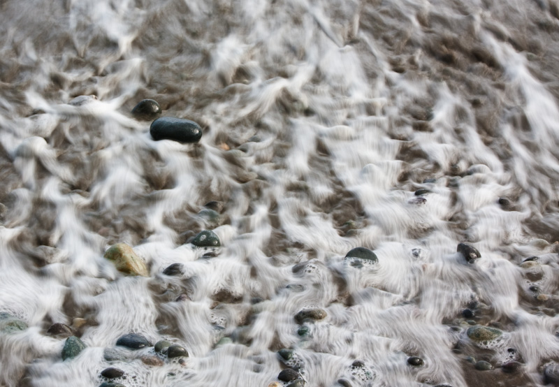 Wave Washing Over Pebbles